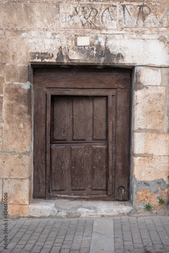wooden door to access the house, old and made of elaborated wood. wooden door to access the house, old and made of elaborated wood.