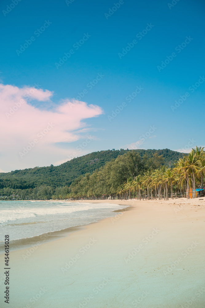 Beach with coconut trees and mountains.View of the coast of the island of island.