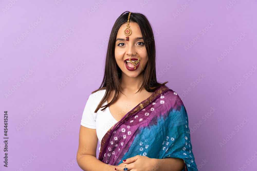 Young Indian woman isolated on purple background with surprise facial expression Young Indian woman isolated on purple background with surprise facial expression