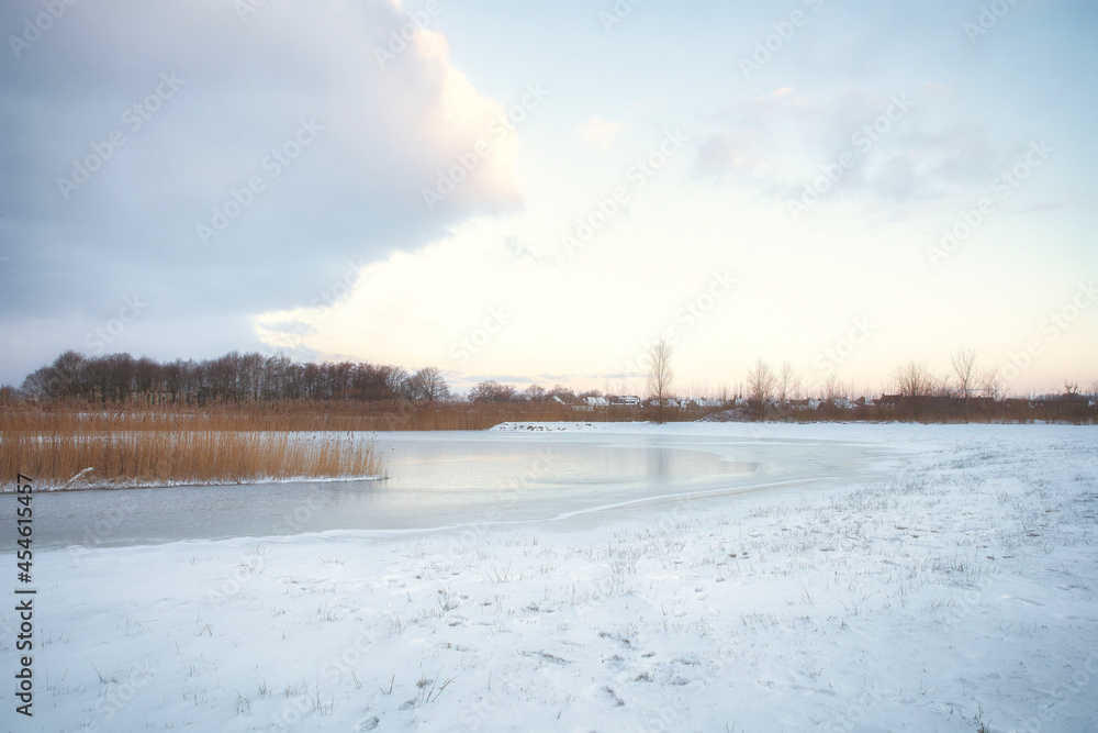 Beautiful winter landscape at sunset with fog and snow covering farmland and river in the Netherlands beautiful colors in nature Beautiful winter landscape at sunset with fog and snow covering farmland and river in the Netherlands beautiful colors in nature