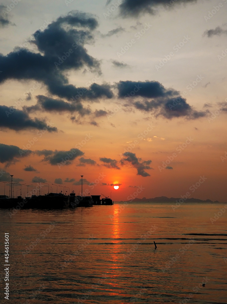 Colorful sunset on the beach. Reflection of the sunset sky in the water