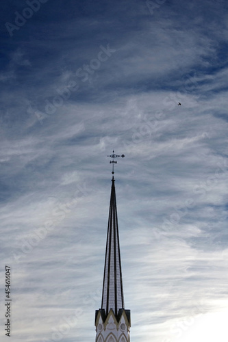 Tall sharp spire under a vivid cloud sky