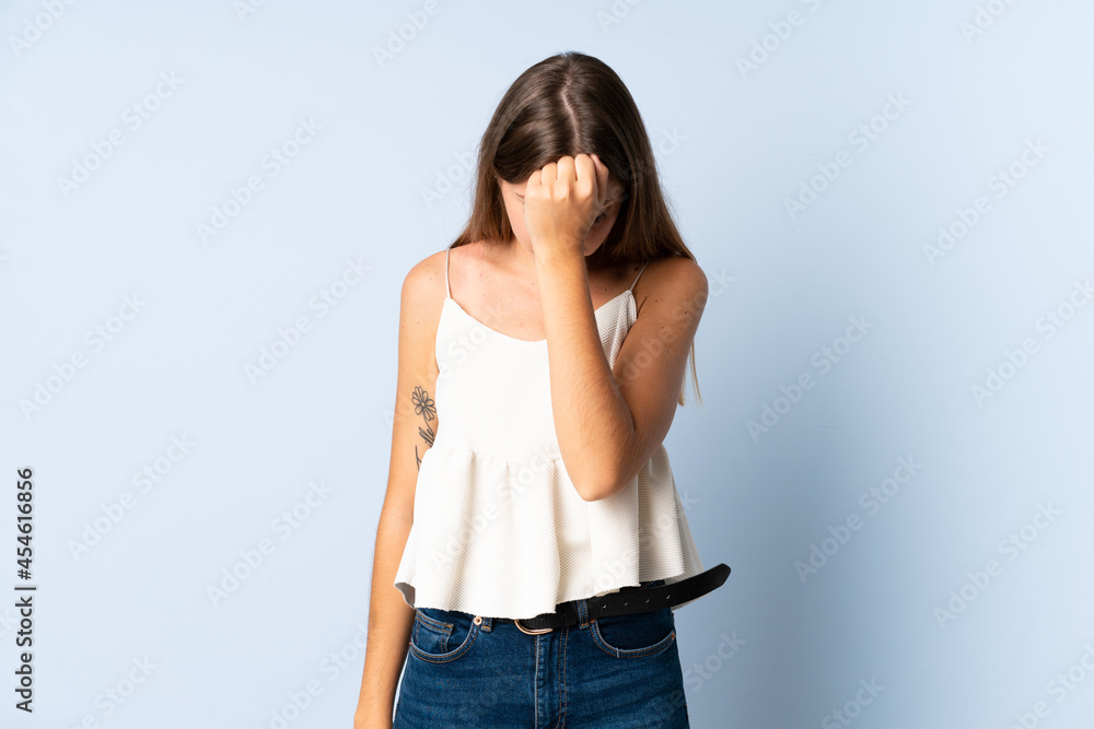 Young Lithuanian woman isolated on blue background with headache Young Lithuanian woman isolated on blue background with headache