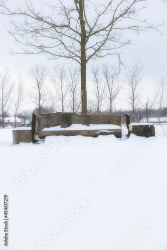 Park bench and trees covered by fresh snow in winter landscape, colorful nature