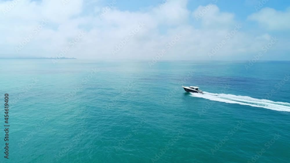 Aerial drone tracking video of white yacht cruising in deep blue ocean Aerial drone tracking video of white yacht cruising in deep blue ocean