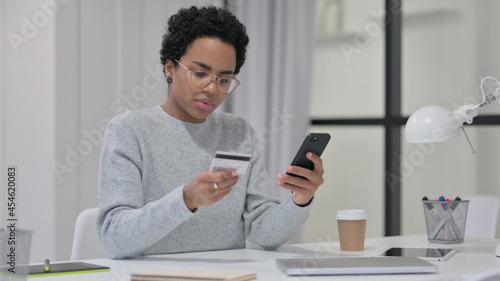 African Woman Excited by Successful Online Shopping on Smartphone