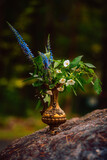 Closeup of vase with flowers outdoors