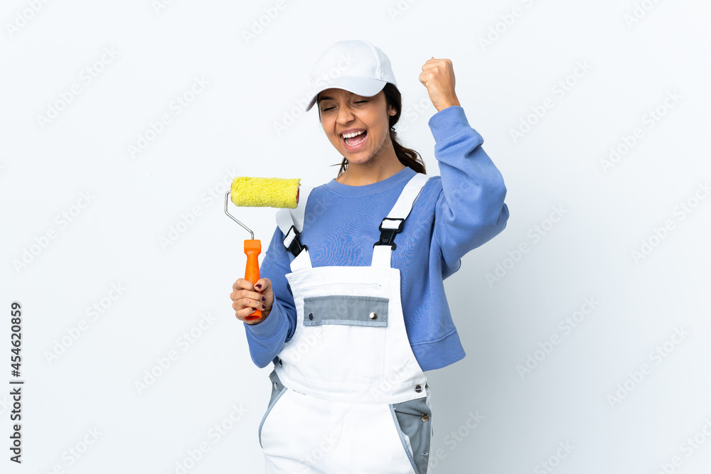 Painter woman over isolated white background celebrating a victory Painter woman over isolated white background celebrating a victory