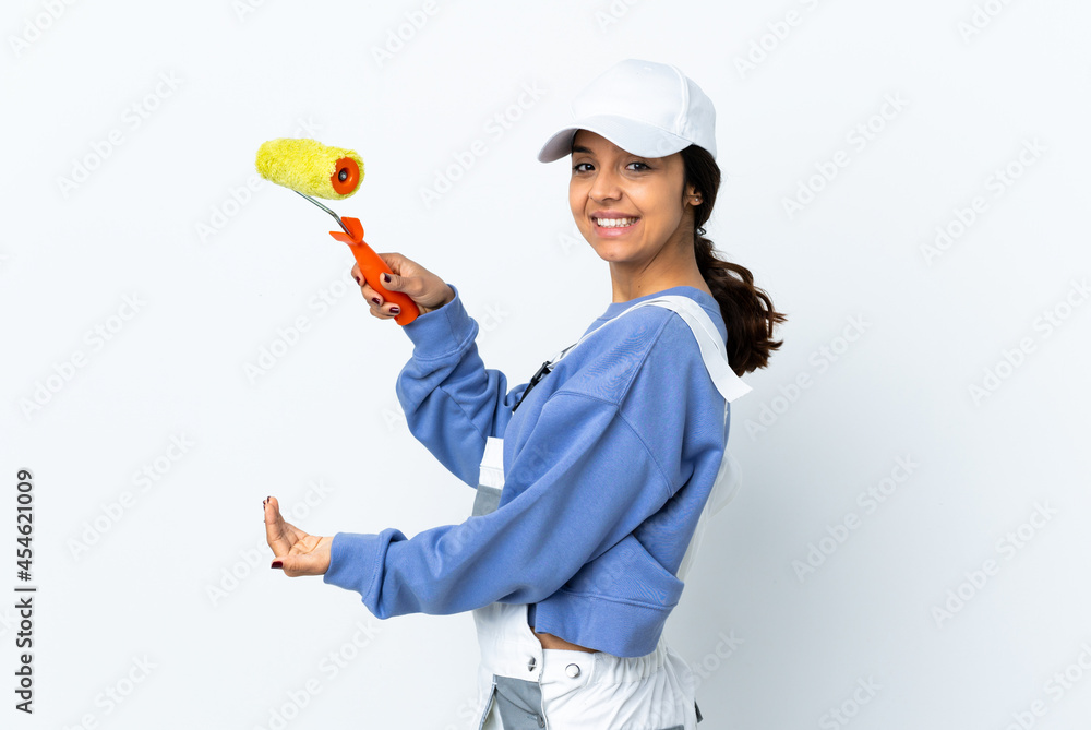 Painter woman over isolated white background holding copyspace to insert an ad Painter woman over isolated white background holding copyspace to insert an ad