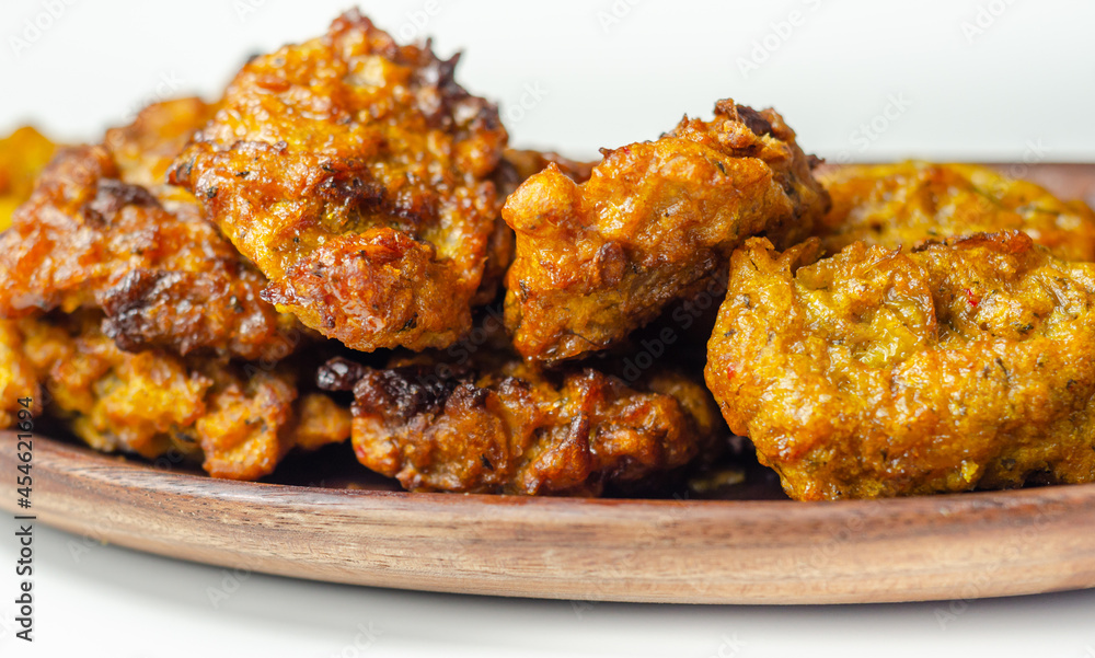 Delicious onion bhaji fritters served on wooden plate as a starter