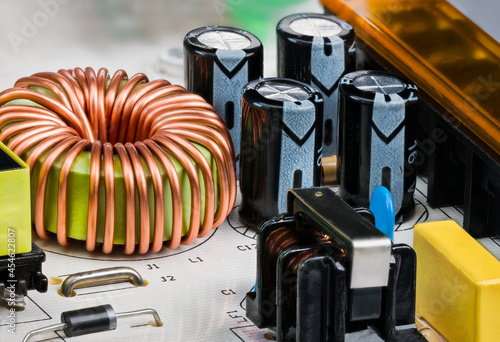 Obraz na plátně Toroidal core inductor, transformer or electrolytic capacitors on PCB detail