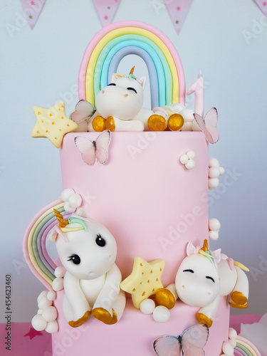 Birthday cake with unicorns and rainbow