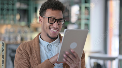 African Man using Digital Tablet, Browsing internet
