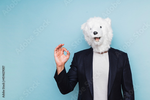 Man with polar bear mask making OK gesture.