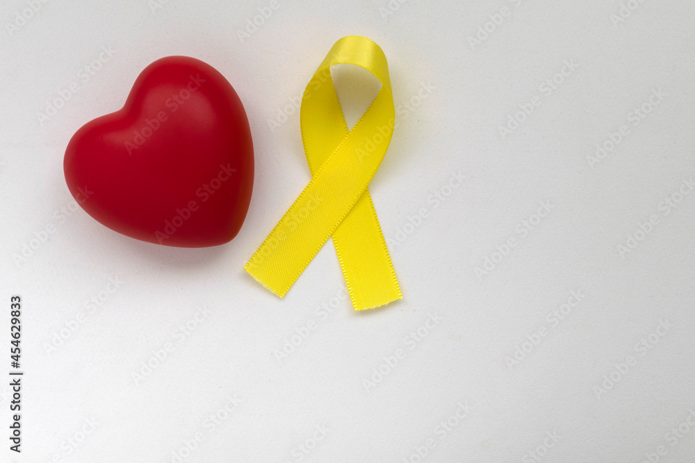 red heart and yellow ribbon of the suicide prevention campaign. Yellow September, suicide prevention. concept of love and prevention.
