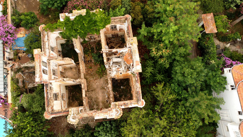 in and outside a destroyed red brick villa on Prinkipo Island, Büyükada in the Sea of Marmara near Istanbul, Turkey  photo