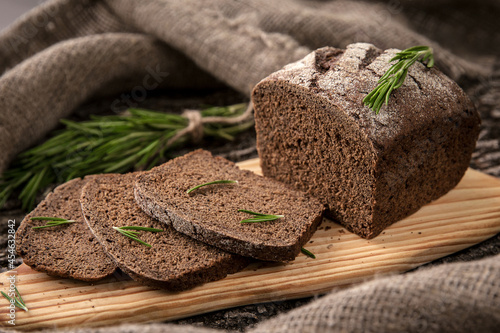 Crusty Fresh Homemade Olive and Rosemary rye bread on Rustic Background