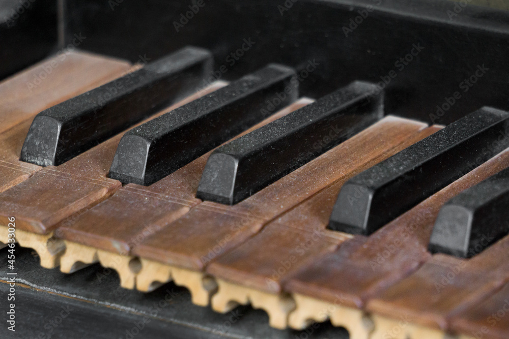 Close up view of old piano or organ keyboard. Close up view of old piano or organ keyboard.