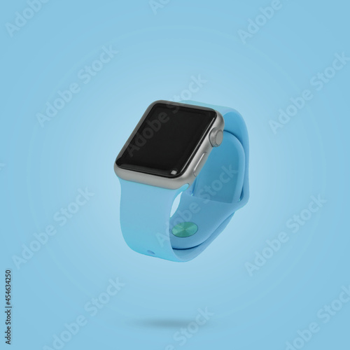 Smart watch floating in air on blue background on pastel blue background.