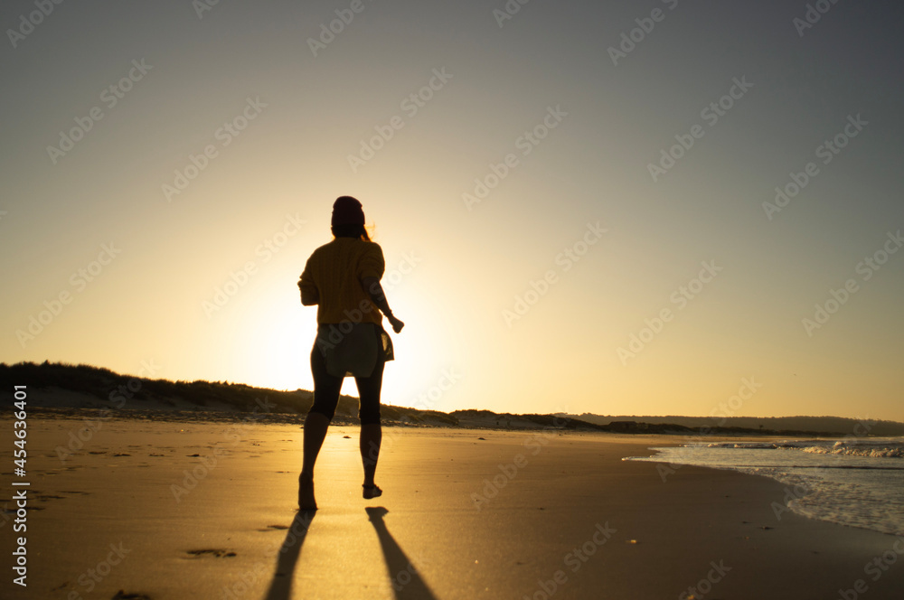 couple walking on the beach at sunset