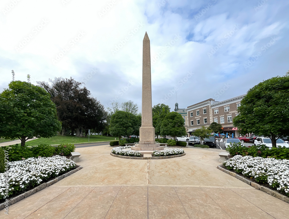 Greenwich, CT - USA - Aug. 29, 2021: Vertical image of Greenwich's World War I monument, a 50-foot obelisk that sits in a small park off of Greenwich Ave