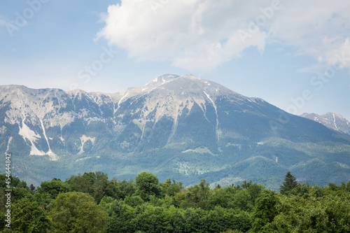 Panorama of the Hochstuhl mount  also called Veliki Stol vrh  between Slovenia and Austria  during a sunset  summit above clouds. It is a major mountain of the Julian Alps  in the karawanks chain.....