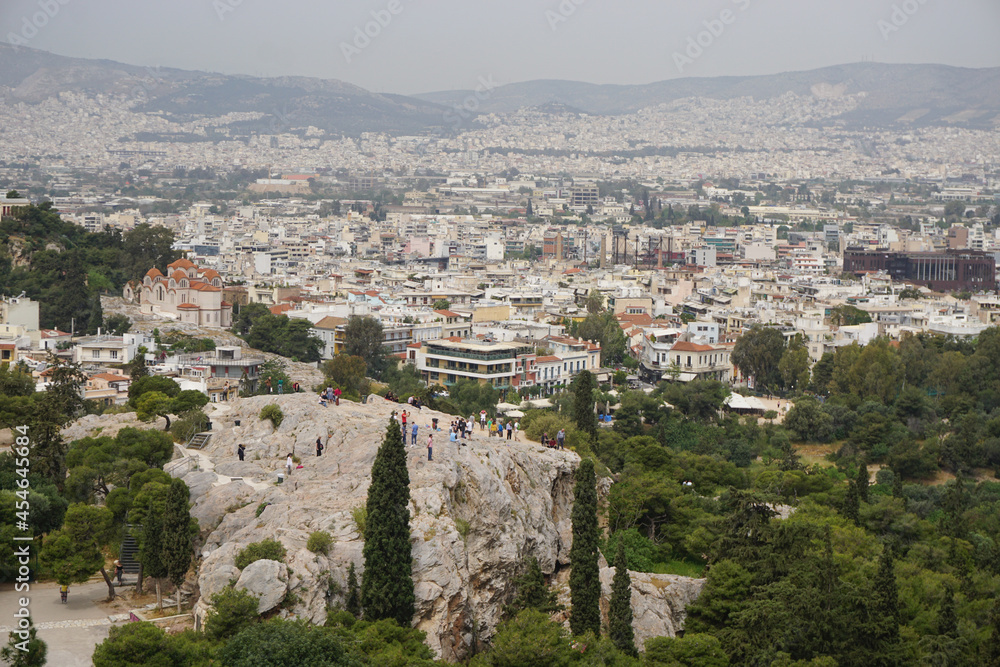 Athens, Greece: View from the Acropolis of the Athens skyline and the Areopagus (Ares Rock), under a hazy sky caused by dust clouds.