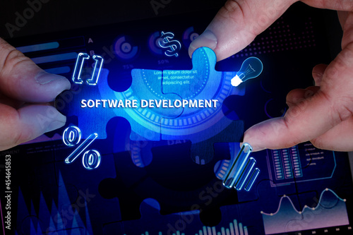 Business, Technology, Internet and network concept. Young businessman working on a virtual screen of the future and sees the inscription: Software development