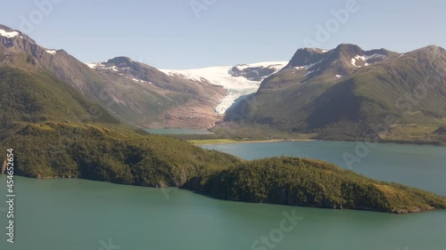 Aerial shot of Svartisen Blackice Glacier beside idyllic Fjord during sunlight - Helgeland, Northern Norway photo