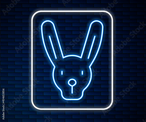 Glowing neon line Rabbit with ears icon isolated on brick wall background. Magic trick. Mystery entertainment concept. Vector