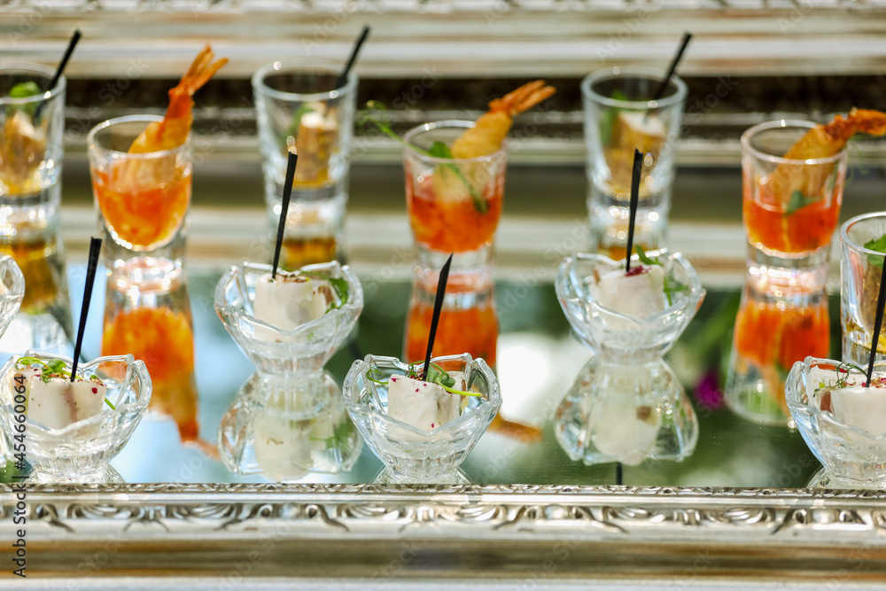 Appetizers, catering, snacks in glassware on the silver tray. High quality photo Appetizers, catering, snacks in glassware on the silver tray. High quality photo