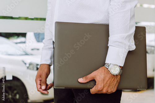 close-up view of a businessman with his lap top in hand