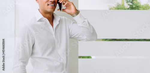 Businessman talking on the phone, business concept, white shirt, modern haircut