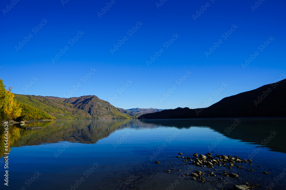 The tranquility of the lake and the mountains. The reflection of the blue sky.