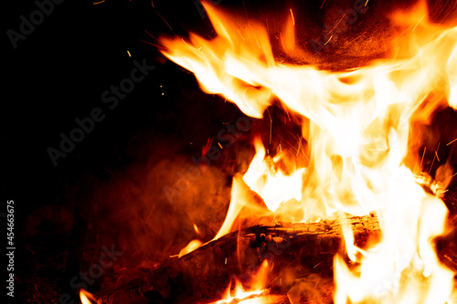 Close-up photo of a campfire. Flames on a black background. Cooking food over a fire.