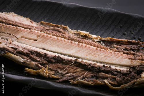 黒いお皿に乗っている秋刀魚の焼き魚の開き　fish 