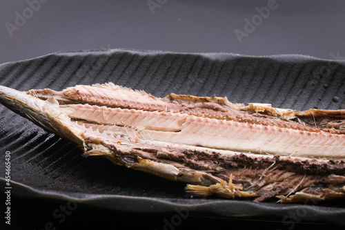 黒いお皿に乗っている秋刀魚の焼き魚の開き　fish 