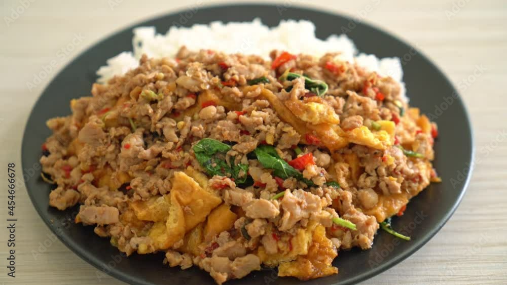 stir-fried minced pork with basil and egg topped on rice - Asian food style stir-fried minced pork with basil and egg topped on rice - Asian food style