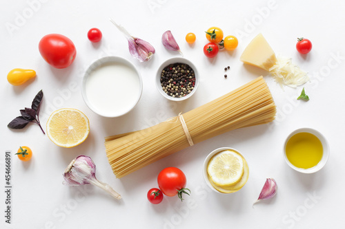Ingredients for Italian pasta on a white background. Top view with copy space. Vegetarian food.