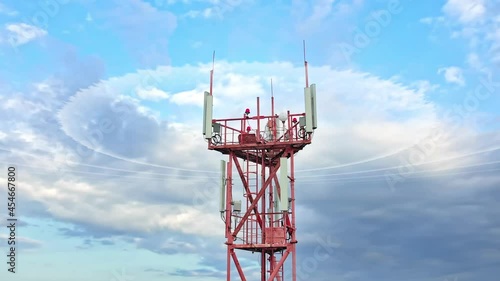 Wireless telecom networking with the transmitter antennae on the mast. Aerial view to telecommunication tower with many internet dishes installed on the construction with radio waves infographic huds.