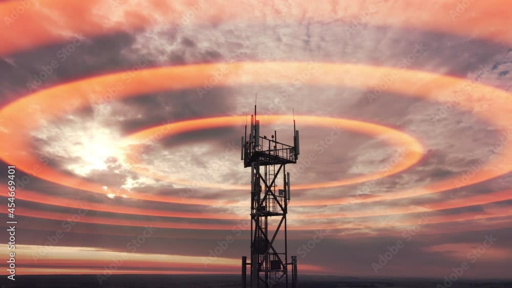 Wireless radiation with aerial footage. Silhouette of tower