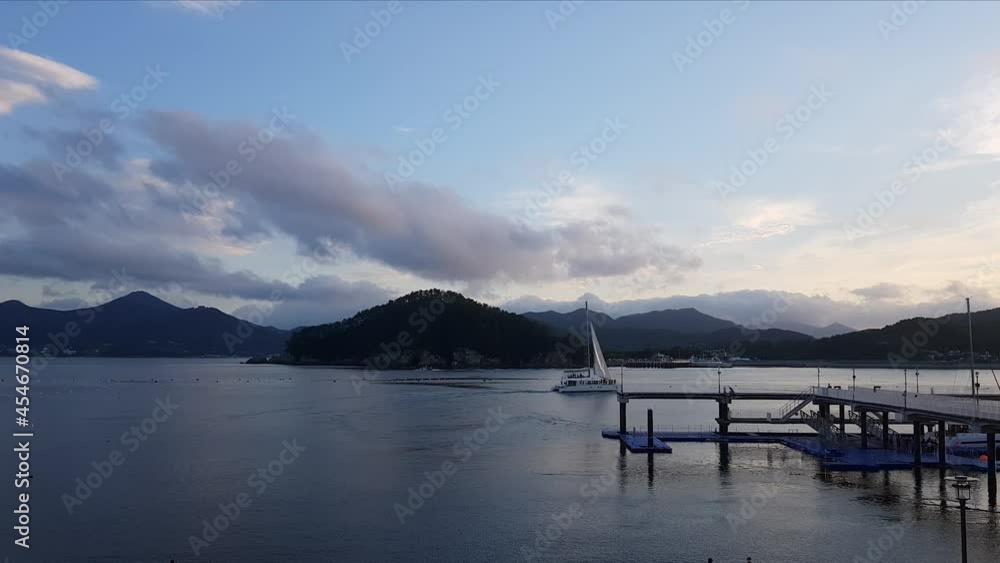 Catamaran Boat Sailing Across Geoje Island Near Hanwha Resort In South Korea. wide shot, tracking Catamaran Boat Sailing Across Geoje Island Near Hanwha Resort In South Korea. wide shot, tracking
