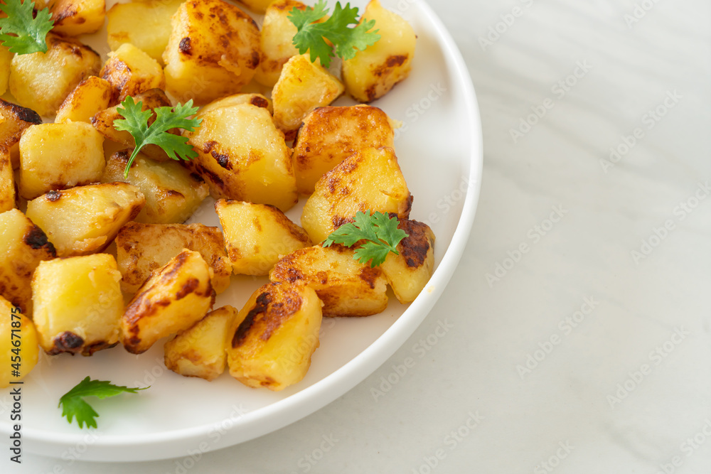 Roasted or grilled potatoes on plate Roasted or grilled potatoes on plate