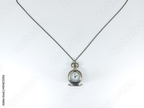 A pocket watch with chain on a white background.