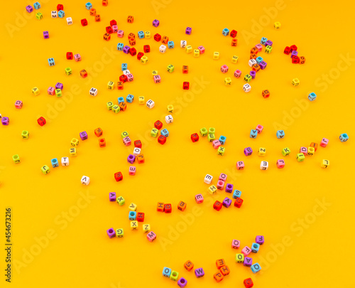 multicolored cubes with letters on a yellow background 