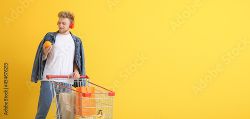 Young man with shopping car...