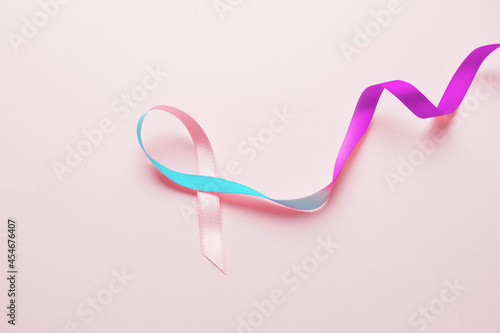 Colorful ribbon on pink background. Thyroid cancer awareness concept photo