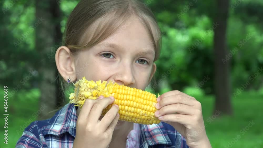 Kid Eating Boiled Corn Outdoor in Park, Hungry Girl Eats Healthy Snack Food, Young Blonde Child Relaxing Outdoor in Nature Kid Eating Boiled Corn Outdoor in Park, Hungry Girl Eats Healthy Snack Food, Young Blonde Child Relaxing Outdoor in Nature