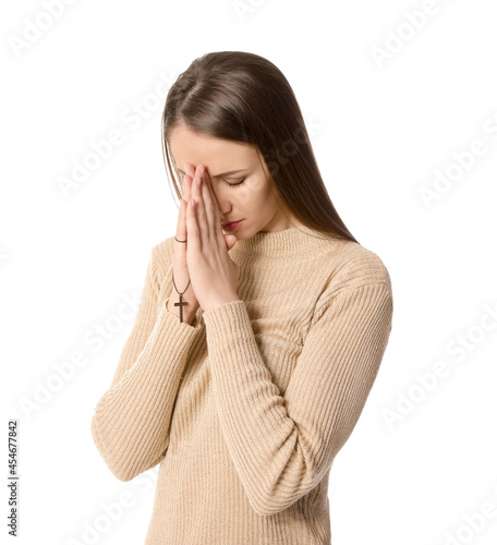 Praying young woman on white background