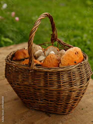 Mushrooms in wooden basket on wooden boards